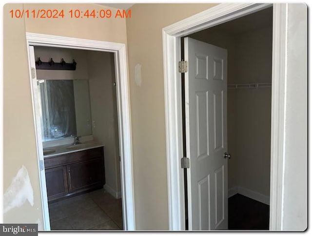 bathroom featuring tile patterned flooring and vanity