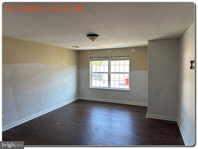 empty room featuring dark wood-type flooring