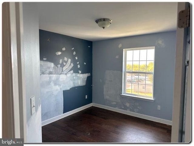 spare room featuring dark hardwood / wood-style flooring