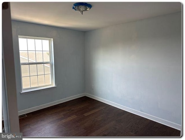 empty room featuring dark hardwood / wood-style floors