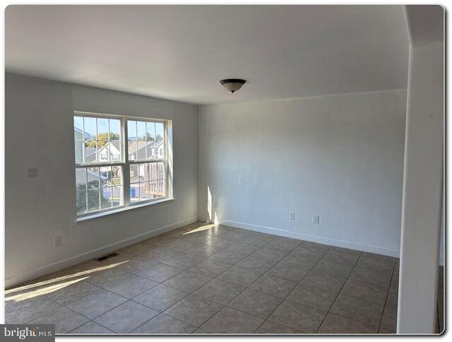 unfurnished room featuring tile patterned flooring