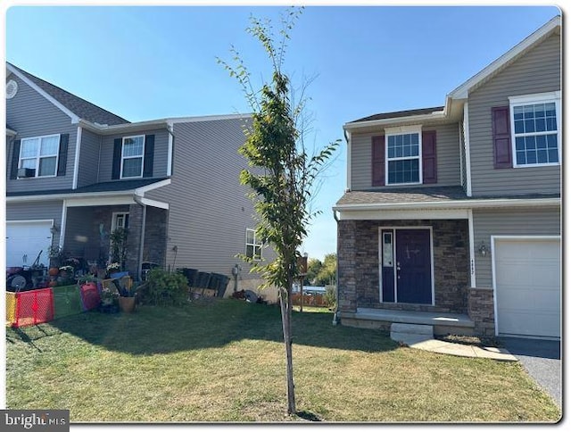 front facade featuring a garage and a front lawn