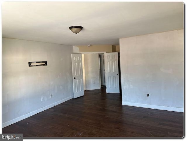 spare room with dark hardwood / wood-style floors