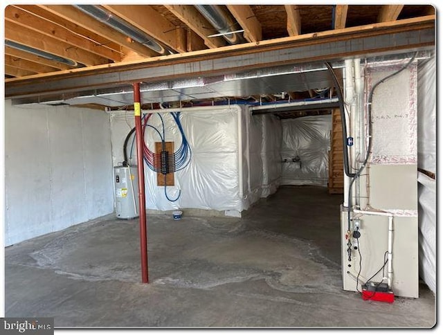 basement featuring heating unit and water heater