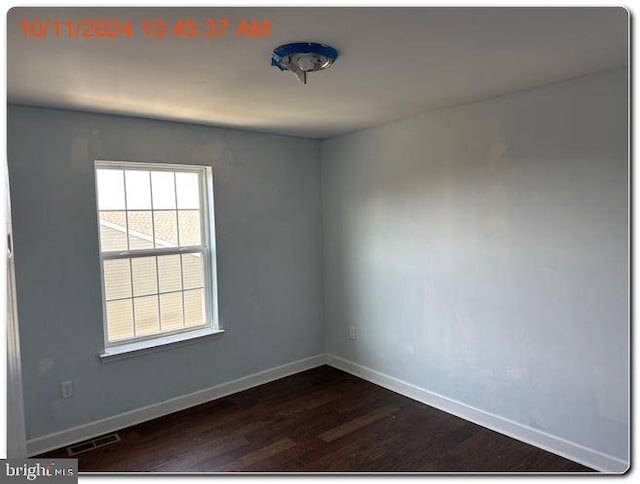 unfurnished room featuring dark hardwood / wood-style flooring