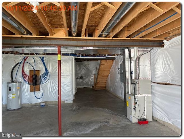 basement featuring heating unit and water heater