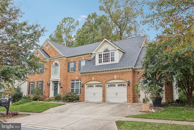 15303 Glastonbury Way, Upper Marlboro, MD 20774 - georgian-style home featuring driveway, brick siding, a front lawn, roof with shingles, and a garage