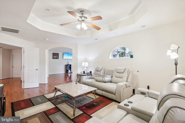 15303 Glastonbury Way, Upper Marlboro, MD 20774 - living area featuring a raised ceiling, ceiling fan, arched walkways, wood finished floors, and crown molding