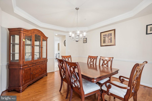 15303 Glastonbury Way, Upper Marlboro, MD 20774 - dining room with a tray ceiling, light wood finished floors, a chandelier, ornamental molding, and baseboards