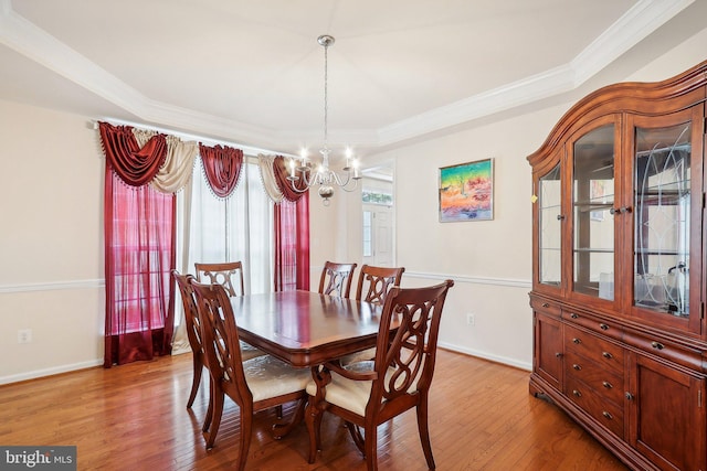 15303 Glastonbury Way, Upper Marlboro, MD 20774 - dining room with a chandelier, light wood-style flooring, crown molding, baseboards, and a raised ceiling