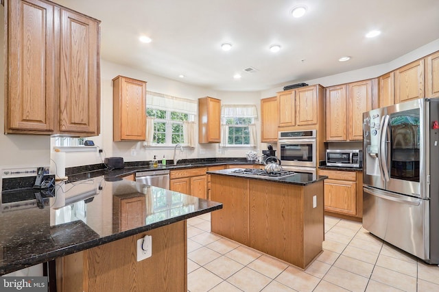 15303 Glastonbury Way, Upper Marlboro, MD 20774 - kitchen with appliances with stainless steel finishes, a sink, dark stone counters, a kitchen island, and light tile patterned flooring