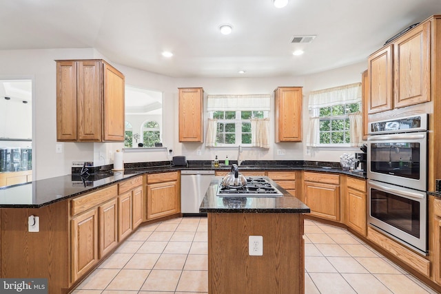 15303 Glastonbury Way, Upper Marlboro, MD 20774 - kitchen featuring stainless steel appliances, a sink, a kitchen island, light tile patterned flooring, and a peninsula