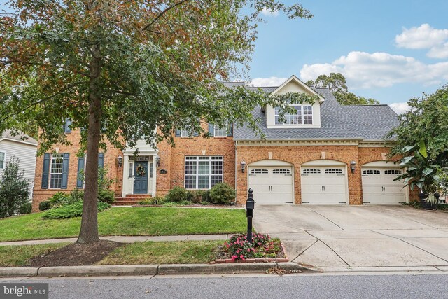 15303 Glastonbury Way, Upper Marlboro, MD 20774 - view of front of home with driveway, brick siding, a front lawn, a shingled roof, and an attached garage