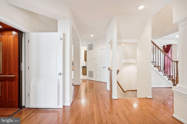 15303 Glastonbury Way, Upper Marlboro, MD 20774 - hallway with wood finished floors, stairs, recessed lighting, baseboards, and ornate columns