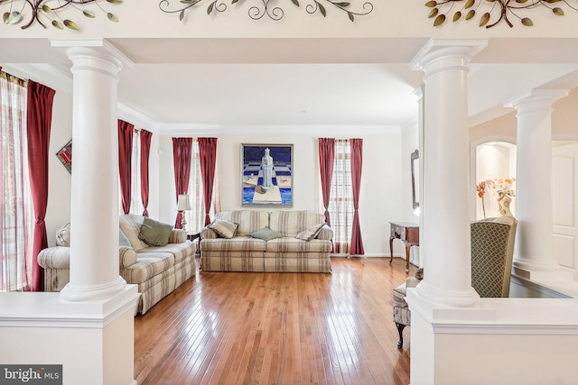 15303 Glastonbury Way, Upper Marlboro, MD 20774 - living area with healthy amount of natural light, ornate columns, light wood-style flooring, and ornamental molding