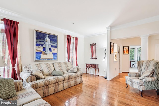15303 Glastonbury Way, Upper Marlboro, MD 20774 - living room featuring decorative columns, crown molding, light wood-style floors, and baseboards