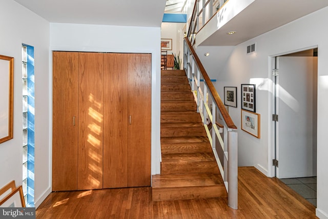 stairs with wood-type flooring