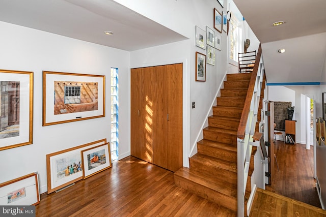 foyer with dark hardwood / wood-style floors and a healthy amount of sunlight