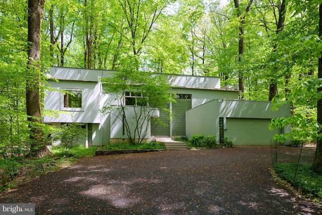 rear view of house featuring a garage