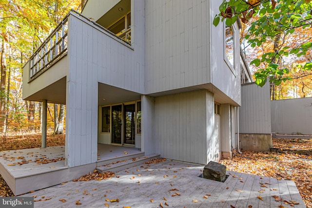 view of side of home featuring a deck and a patio area