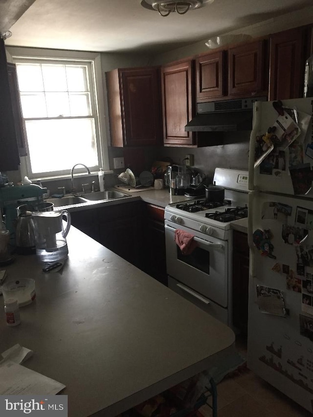 kitchen with sink, white appliances, and extractor fan