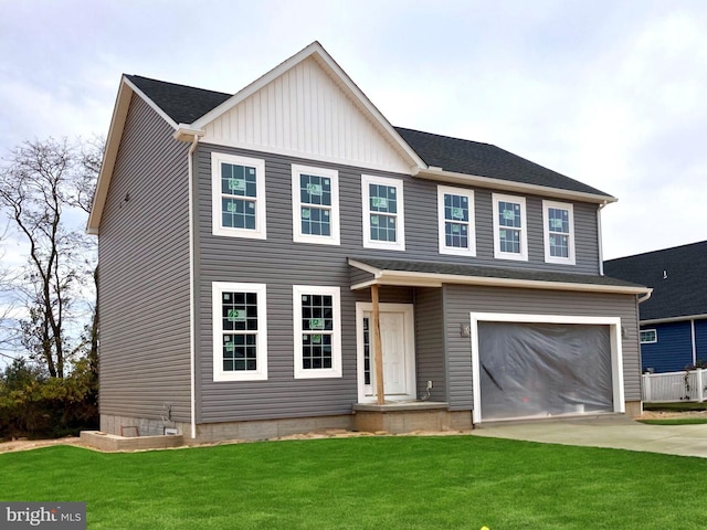 view of front of house with a garage and a front lawn