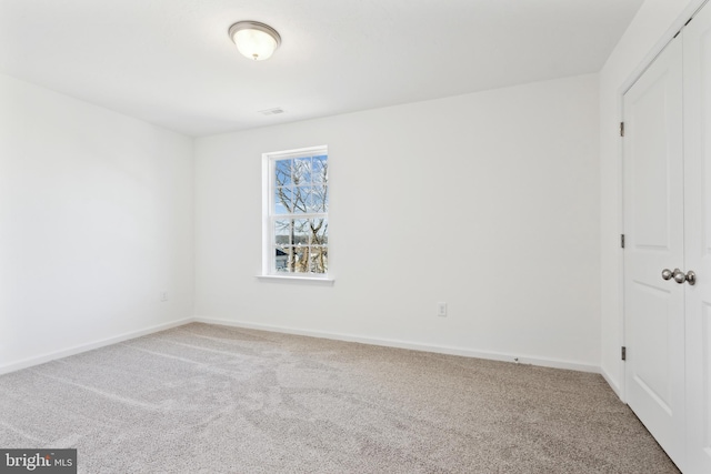 unfurnished bedroom with carpet floors, a closet, and baseboards