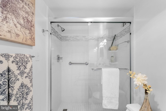 bathroom with a shower with door