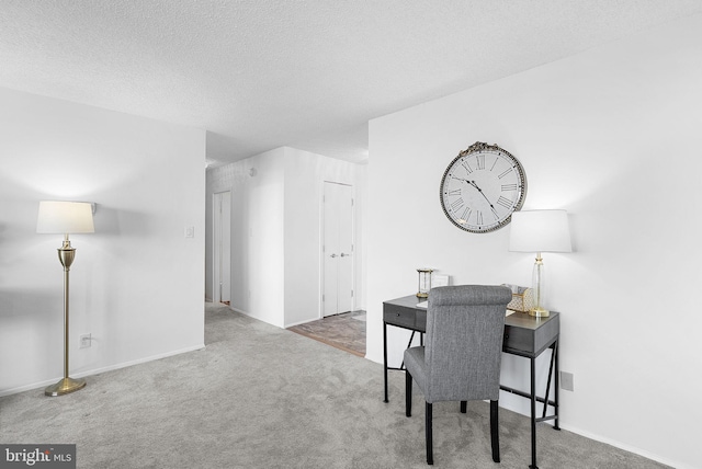 carpeted office with a textured ceiling