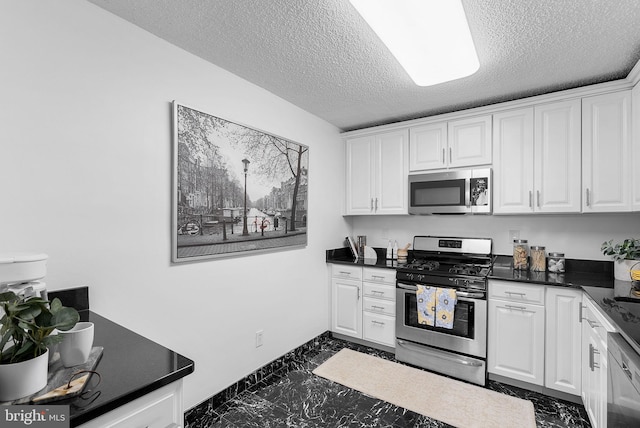 kitchen featuring white cabinetry, appliances with stainless steel finishes, and a textured ceiling