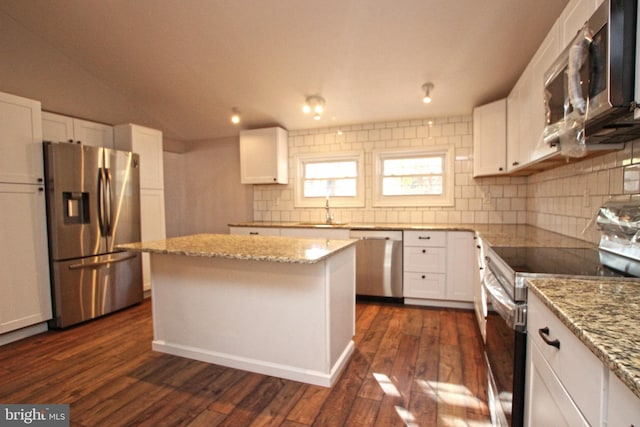 kitchen featuring dark wood-type flooring, white cabinets, and stainless steel appliances