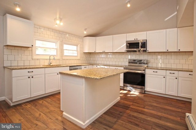 kitchen with sink, appliances with stainless steel finishes, a baseboard heating unit, and white cabinetry