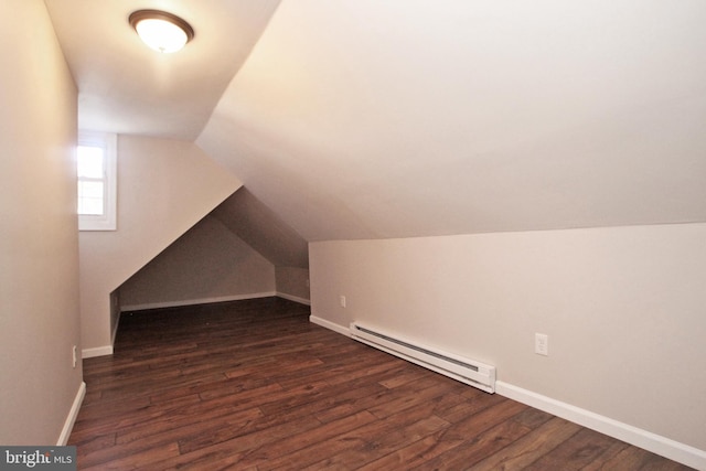 bonus room featuring baseboard heating, dark wood-type flooring, and vaulted ceiling