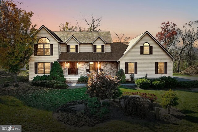 41 Howard Dr, East Berlin, PA 17316 - view of front facade featuring a front lawn, a shingled roof, and stone siding