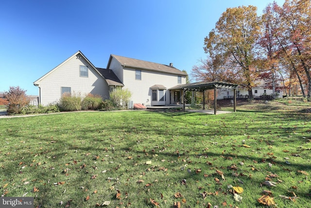 rear view of property featuring a patio area, a lawn, and a pergola