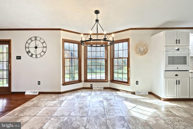 unfurnished dining area featuring ornamental molding, a chandelier, and light hardwood / wood-style floors