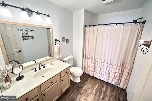 bathroom featuring vanity, toilet, hardwood / wood-style flooring, and a shower with shower curtain