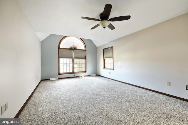 carpeted empty room featuring lofted ceiling and ceiling fan