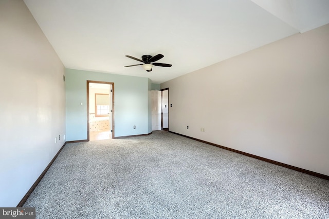 unfurnished bedroom featuring ensuite bath, carpet floors, and ceiling fan