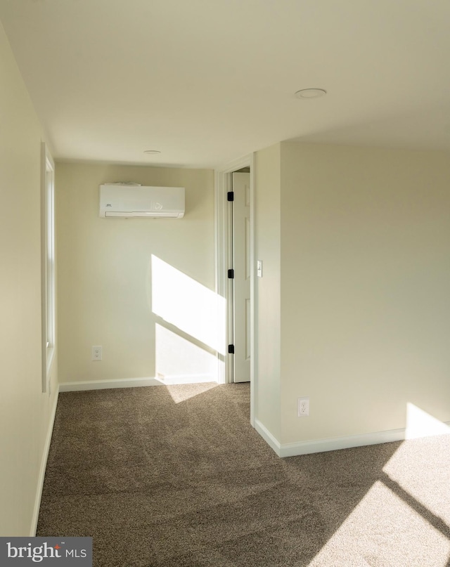 carpeted empty room with an AC wall unit