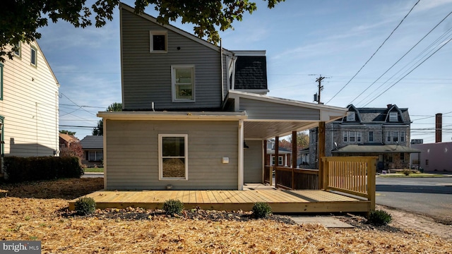 rear view of property featuring a deck