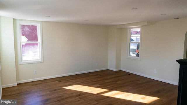 empty room with dark hardwood / wood-style floors