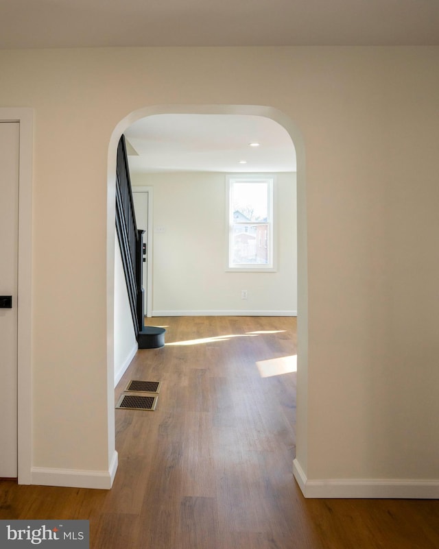 hall with hardwood / wood-style flooring