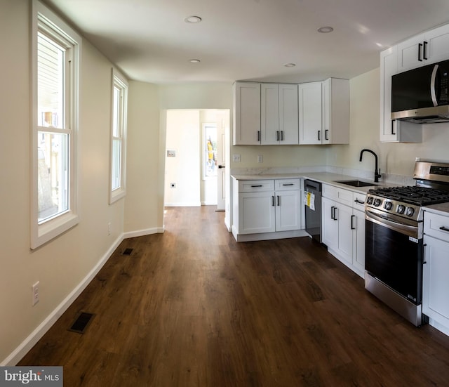 kitchen featuring sink, appliances with stainless steel finishes, dark hardwood / wood-style floors, and white cabinets