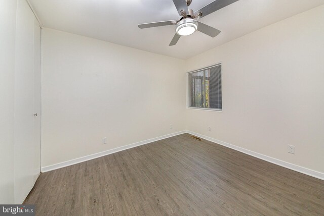 empty room featuring ceiling fan and dark hardwood / wood-style floors