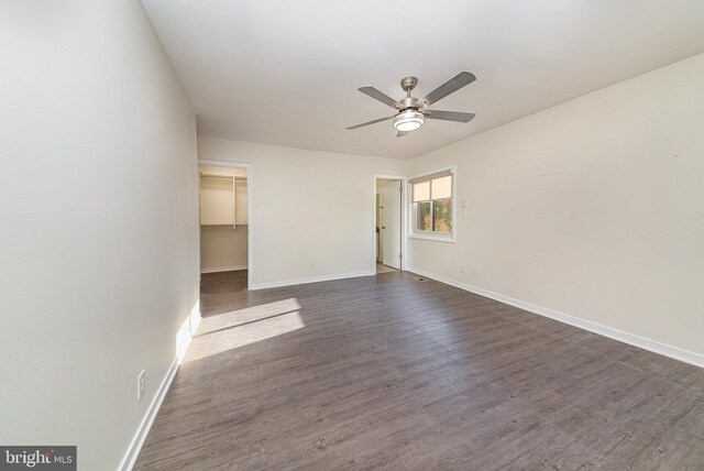 spare room with dark wood-type flooring and ceiling fan