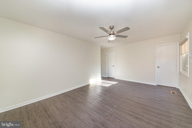 spare room featuring dark hardwood / wood-style floors and ceiling fan