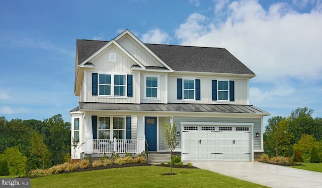 view of front of home featuring covered porch, a garage, and a front lawn