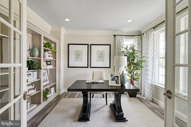 office space featuring french doors, dark wood-type flooring, plenty of natural light, and crown molding