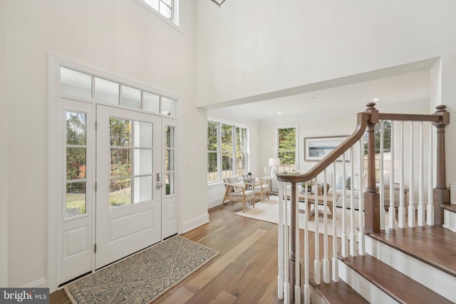 entrance foyer featuring light hardwood / wood-style floors and a towering ceiling